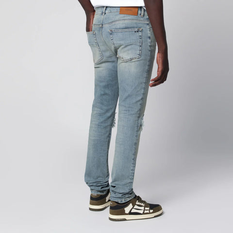 AMIRI MX1 distressed flannel-patched jeans in medium indigo