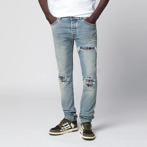 AMIRI MX1 distressed flannel-patched jeans in medium indigo