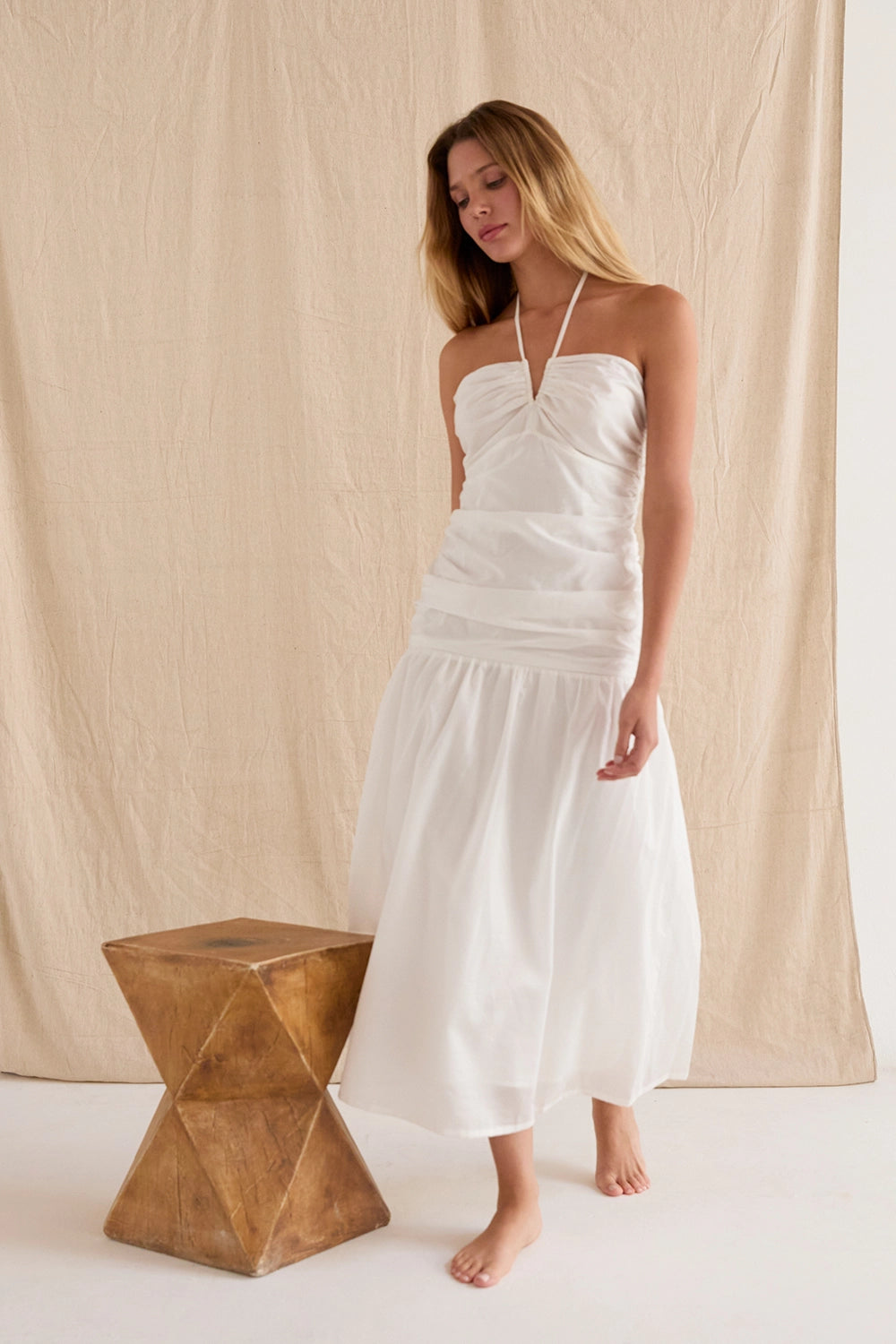 Rayna Shirred Halter Midi Dress from Crescent exclusive at Urbanheer. Rayna Shirred Halter Midi Dress from Crescent exclusive at Urbanheer.