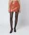 THE ANDAMANE Leather-effect mini skirt in tan